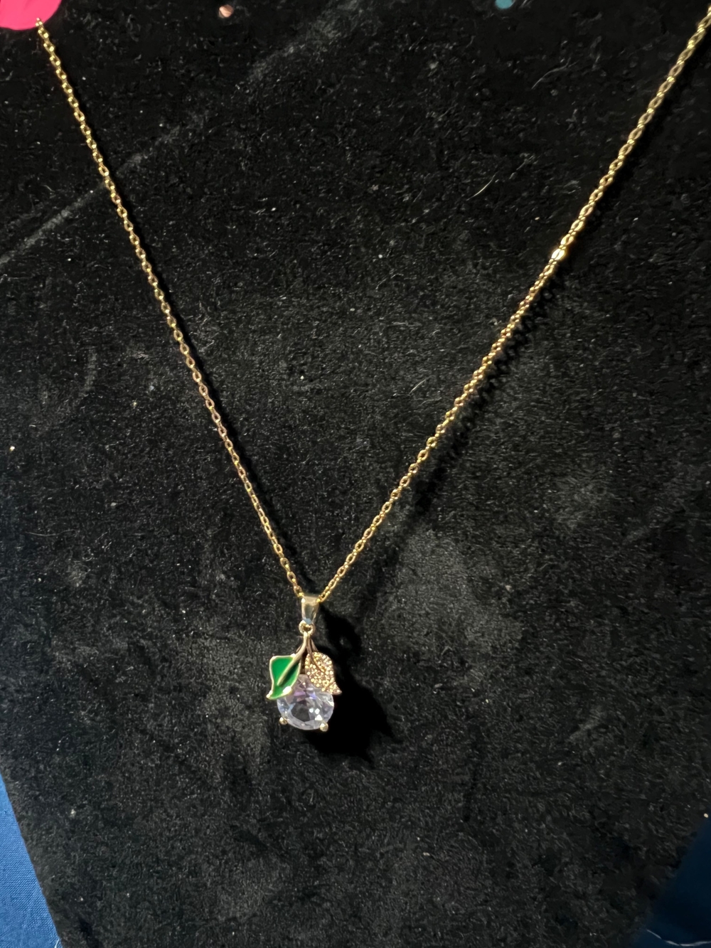 Gold Tone Necklace with Green Enamel Leaf and Clear Crystal Pendant